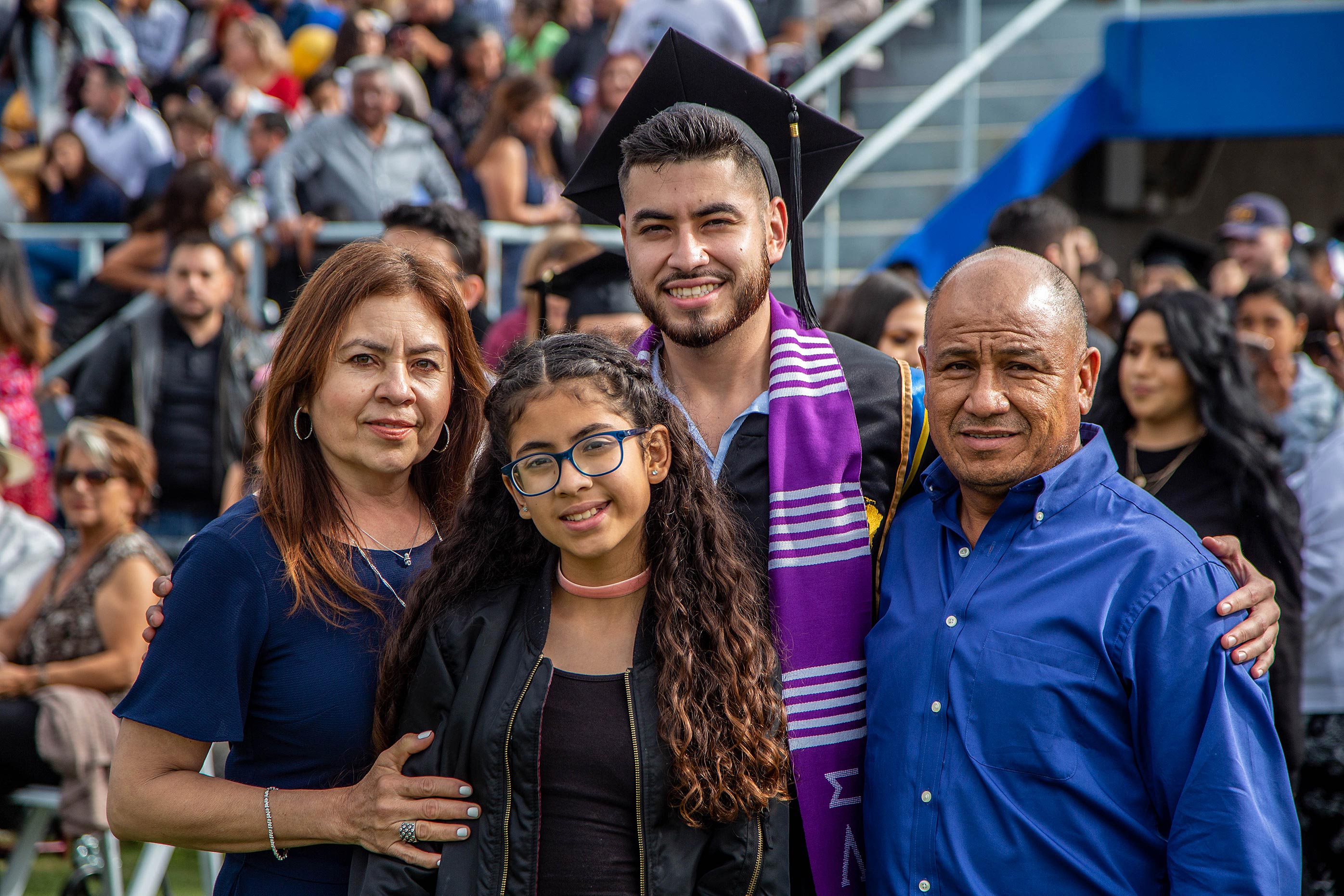 Family around new graduate at Commencement