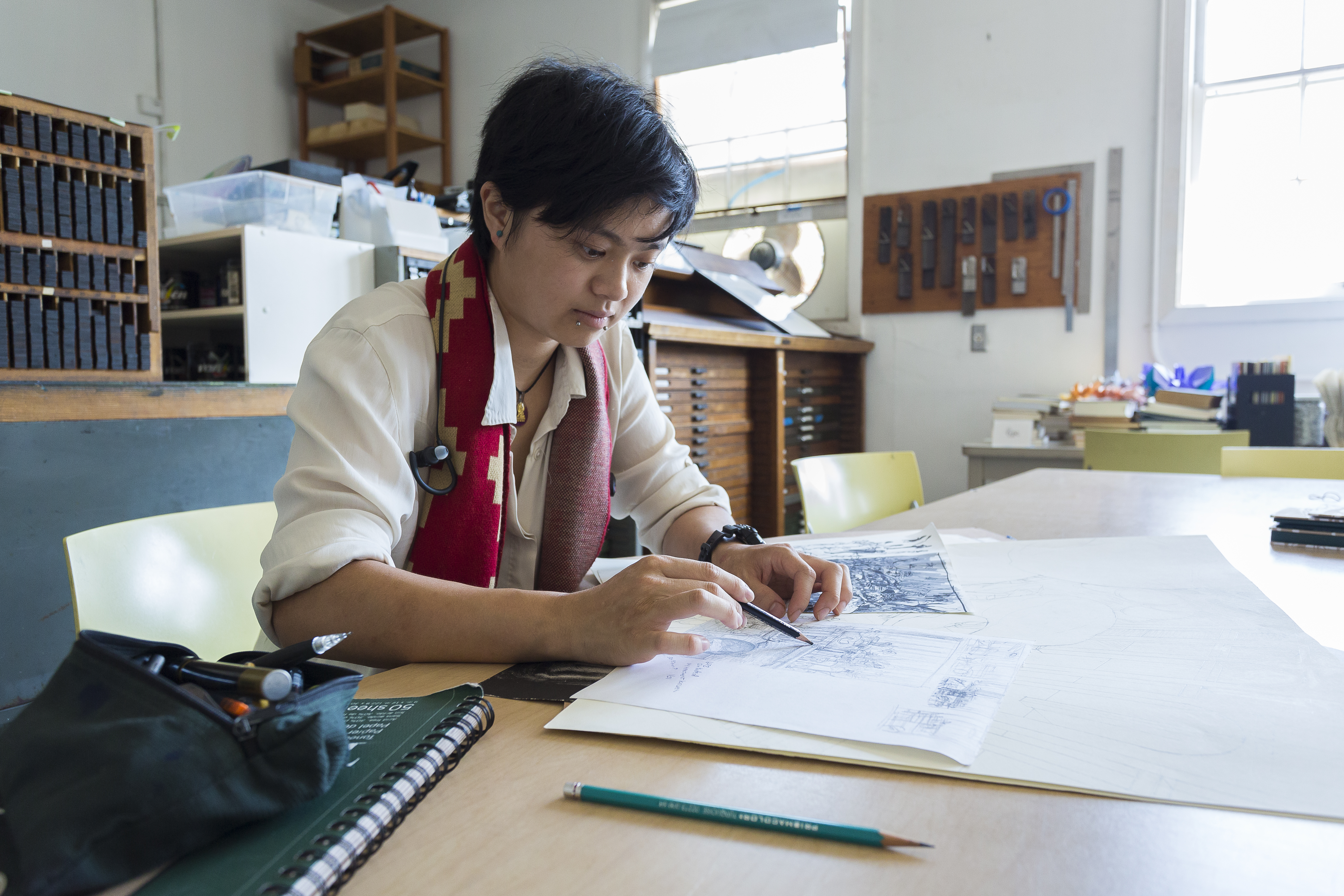 Student drawing at desk